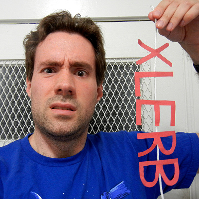 (picture of me, holding up a string with paper letters spelling XLERB glued to it)